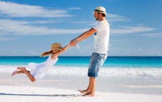 man on vacation playing with a child